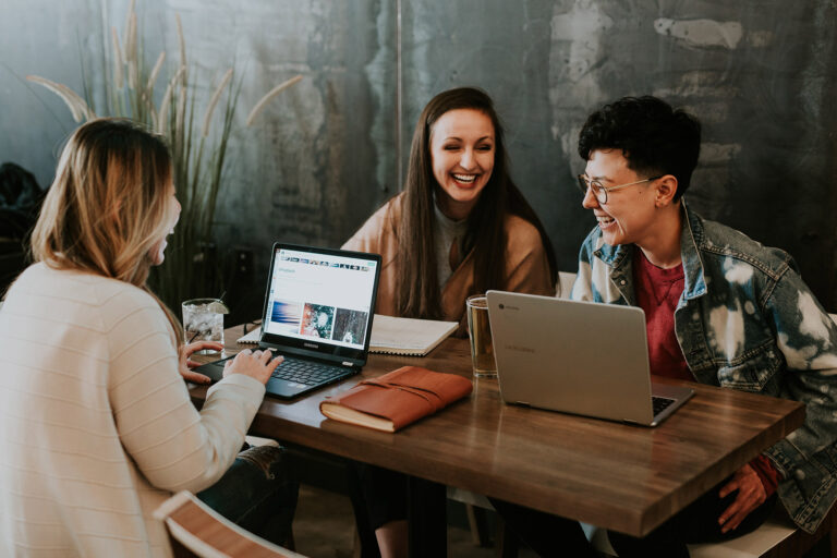Group of people working a table - employer branding